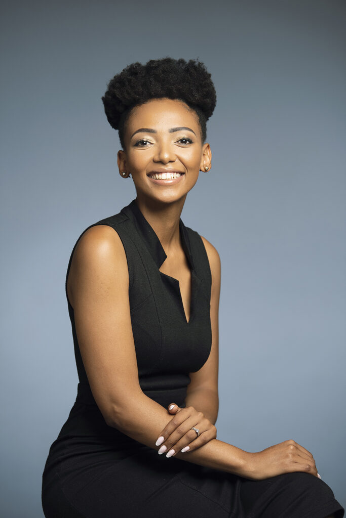 Woman's professional business/ corporate headshot on dark studio backdrop shot by Kevin Mark Pass Photography, makeup by Storm Pass Makeup